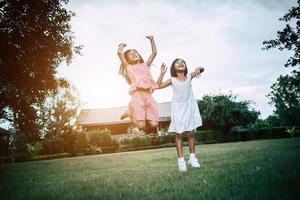 Two little girls having fun playing in the park photo