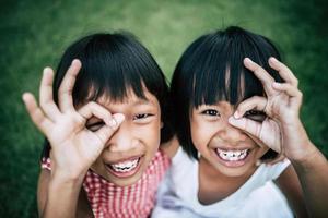 Two little girls having fun playing in the park photo