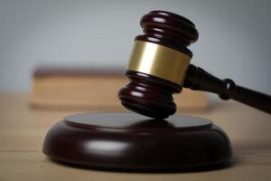 Close-up of a judge's hammer on a wooden background photo