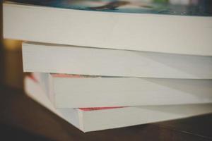 Close-up of a pile of books on a wooden table photo