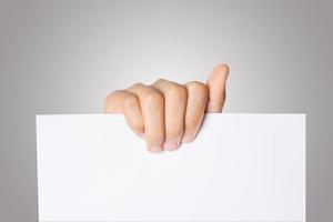 Close-up of a woman's hand holding blank paper isolated on white background photo