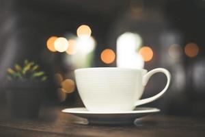 Vintage style effect photo of a coffee cup in a cafe