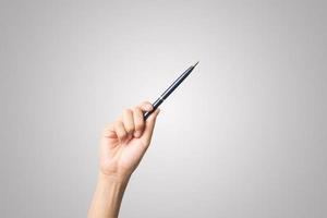 Woman's hand holding a pen isolated on white background photo