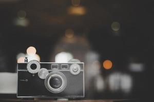 Vintage or retro camera on a wooden table at a cafe photo