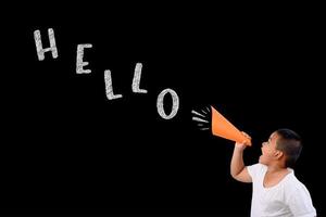 Young boy shouts loudly HELLO on black chalkboard photo