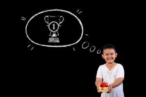 Young boy showing number 1 on a blackboard photo