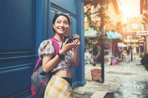 Portrait of a pretty young hipster woman having fun in the city photo