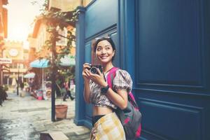 Portrait of a pretty young hipster woman having fun in the city photo