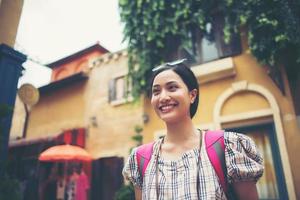 Young hipster woman taking photos in an urban area