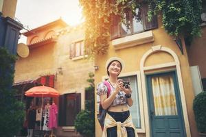 Young hipster woman enjoying taking a photo in urban setting