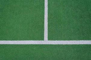 White boundary lines on a green field photo