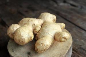 Ginger on wooden background photo