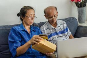 Two elderly people shopping online photo