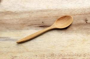 Wooden spoon on wooden background photo