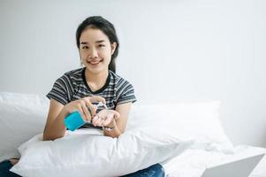 Young woman using hand washing gel photo