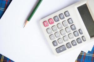 Calculator and pencil on the desk photo