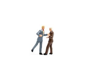 Two male figurines dancing on white background photo