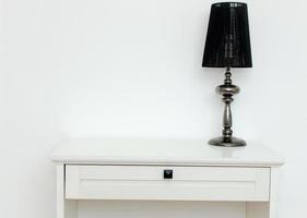 Black lamp on white dresser photo