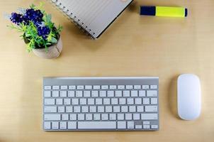 Top view of keyboard and wireless mouse on desk photo