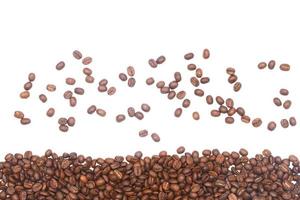 Scattered and piled coffee beans photo