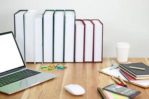 Laptop with books mock-up photo