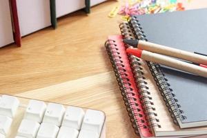 Workspace with notebooks and pens photo