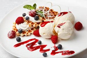 Vanilla ice cream and waffles with fresh berries photo