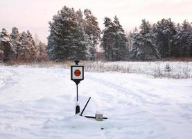 Railway traffic light in snow photo