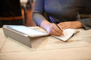 Woman taking down information in notebook photo