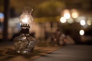 Antique oil lamp on table photo