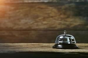 Service bell on rustic wooden background photo