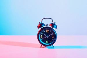 Alarm clock on pastel background photo