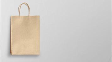 Brown paper shopping bag on gray background photo