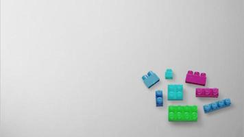 Colorful plastic building blocks on gray background