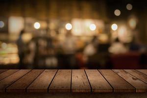 Wood table top for display with blurred restaurant background photo