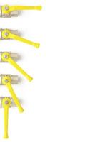 Top view of set of faucets with yellow levers on white background photo