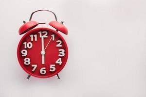 Red alarm clock isolated on a white background photo