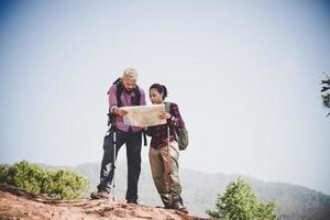 Young tourist couple hiking to a mountain photo