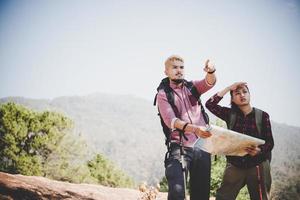 Backpackers couple hiking outdoors photo