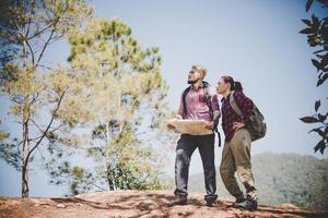 Backpackers couple hiking outdoors photo