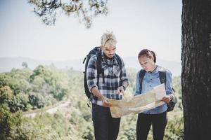 Young adventure couple hiking to a mountain photo