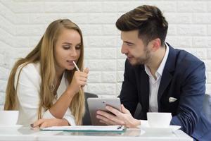 Happy colleagues meeting together while working at office photo