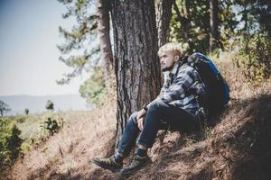 Young man traveling with a backpack in nature photo