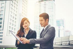 Business colleagues standing in front of office photo