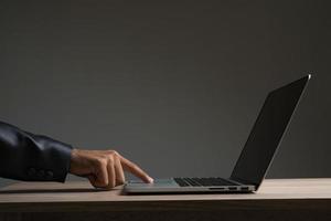 Young businessman sitting working with laptop isolated photo