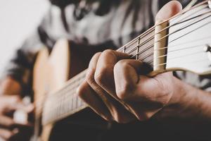 Close up of man hand playing guitar photo
