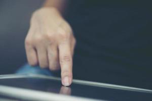 Close-up of hands using tablet sitting and relaxing photo