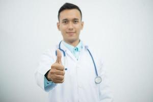 Doctor with stethoscope gives thumbs up photo