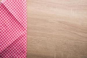 Checkered red napkin on wooden background photo