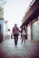 Portrait of a hipster couple walking in the street photo